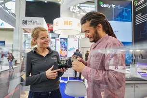 A woman and a man talking about electronic components