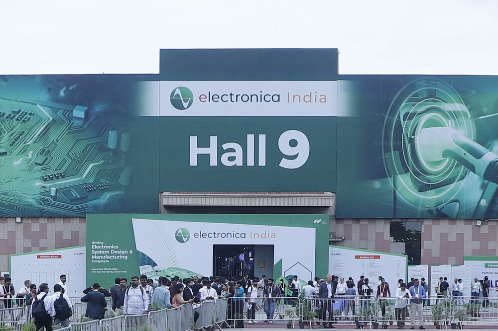 A crowd gathers in front of Hall 9 at electronica India, with banners and a visible entrance.