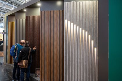 Various wall panels can be seen at a trade fair booth.