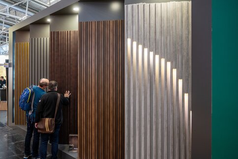 Various wall panels can be seen at a trade fair booth.