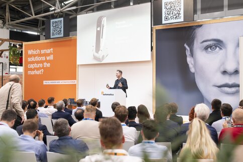 A speaker is presenting to an audience of experts.