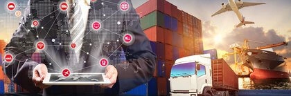 A man with a tablet with network icons hovering over it stands in front of stacked freight containers, a truck, an airplane and a cargo ship in the background.