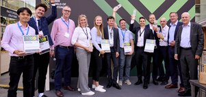 The presenters and winners of the Innovation Award standing on stage with their trophies and certificates in hand – a total of 12 people.