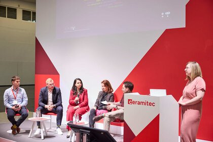 Panel discussion on the ceramitec stage with several participants and a moderator.