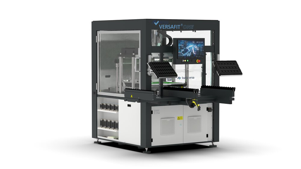 A rectangular machine with transparent window fronts and a black frame, various panels and a screen in front of it.