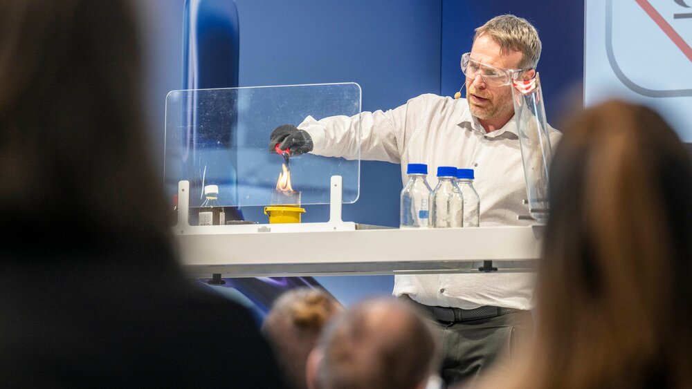 Live demonstration with an experiment performed on stage in front of an audience.