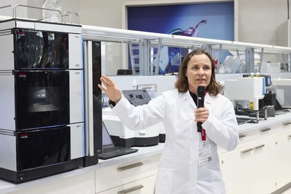 a woman in a lab coat gives a lecture