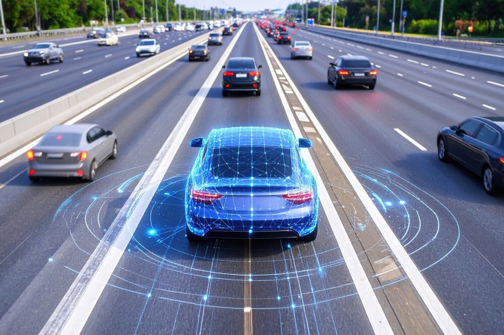 An autonomous car is driving on a multi-lane highway among other vehicles. Digital sensor and network graphics are displayed around the blue car, visualizing self-driving technology and vehicle detection systems.
